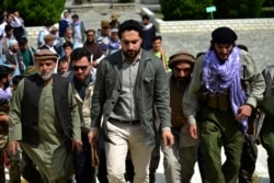 FILE - Ahmad Massoud (C), son of the late Afghan commander Ahmad Shah Massoud and leader of the National Resistance Front, arrives to attend and address a gathering at the tomb of his late father, in Panjshir province, Afghanistan, July 5, 2021.