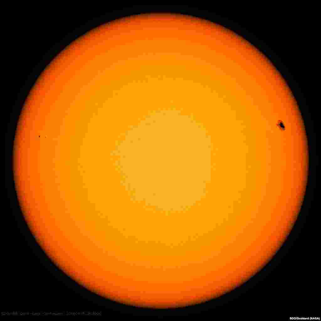 A black spot on the sun is visible in the upper right of this image captured by NASA's Solar Dynamics Observatory. Such spots are evidence that this is an area of complex magnetic activity on the sun, which can sometimes lead to solar eruptions sending light and radiation out into space. This region produced a solar flare at 8:29 p.m. EDT on April 17, 2016.