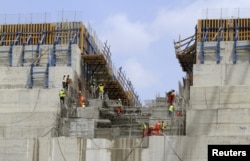 FILE - Construction workers are seen in a section of Ethiopia's Grand Renaissance Dam, as it undergoes construction, during a media tour along the river Nile in Benishangul Gumuz Region, Guba Woreda, in Ethiopia, March 31, 2015.