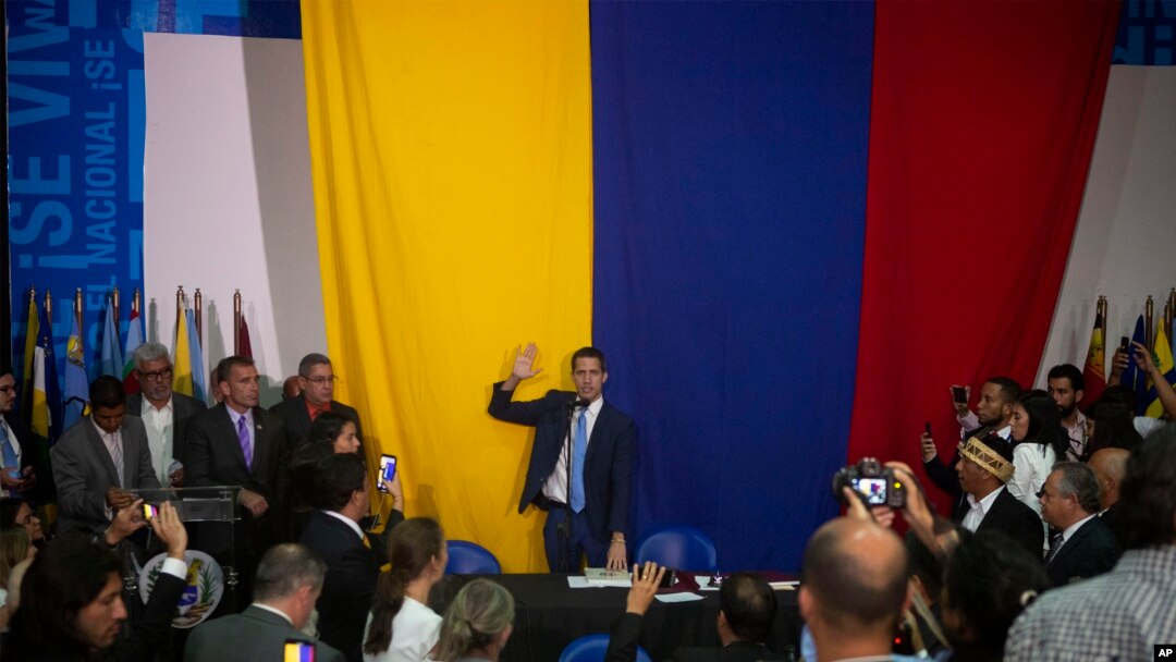 Opposition leader Juan Guaido swears himself in as president of the National Assembly with opposition lawmakers at the newspaper El Nacional's headquarters in Caracas, Venezuela, Jan. 5, 2020.