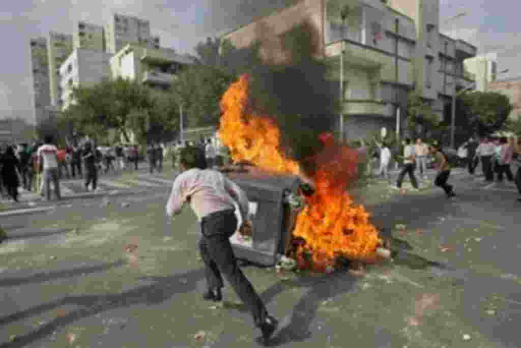 Supporters of opposition leader Mir Hossien Mousavi attend during protest in Tehran on Saturday June, 20, 2009. Eyewitnesses described fierce clashes after some 3,000 protesters, many wearing black, chanted 'Death to the dictator!' and 'Death to dictators