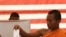 Cambodian Buddhist monk, right, casts his ballot in local elections at Wat Than pagoda's polling station in Phnom Penh, Sunday, June 3, 2012. 