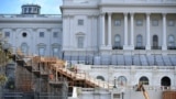 In this file photo workers construct the stage for the presidential inauguration at the US Capitol in Washington, DC, on December 1, 2020. (Photo by MANDEL NGAN / AFP)