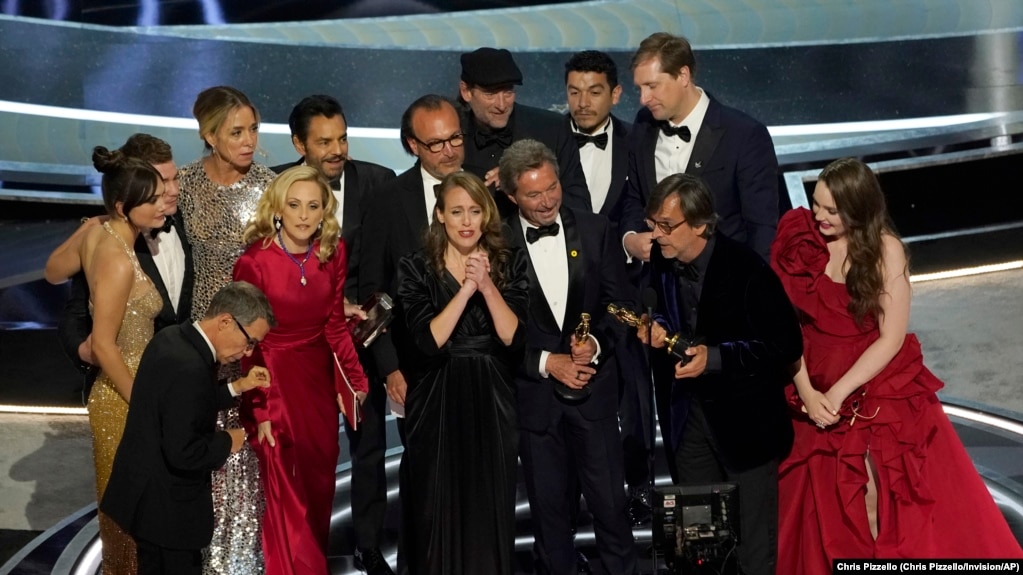 The cast and crew of "CODA" accept the award for best picture at the Oscars on Sunday, March 27, 2022.