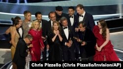 The cast and crew of "CODA" accept the award for best picture at the Oscars on Sunday, March 27, 2022.
