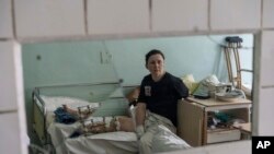 Natalya Vakula, 44, rests in a hospital in Brovary, on the outskirts of Kyiv, while recovering from injuries after a Russian attack in Chernihiv, Ukraine, March 26, 2022.