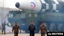 North Korean leader Kim Jong Un walks away from what state media report is a "new type" of intercontinental ballistic missile (ICBM) in this undated photo released on March 24, 2022, by North Korea's Korean Central News Agency (KCNA).