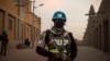 FILE - Policemen of the United Nations Stabilization Mission in Mali (MINUSMA) patrol in front on the Great Mosque in Timbuktu, Mali, Dec. 8, 2021.