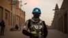 FILE - Policemen of the United Nations Stabilization Mission in Mali (MINUSMA) patrol in front on the Great Mosque in Timbuktu, Mali, Dec. 8, 2021.