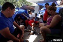 Migrants rest at a makeshift camp in a public square, in Reynosa, Mexico, March 31, 2022.