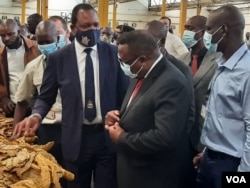 Government officials at the tobacco auction floor in Harare on Wednesday.