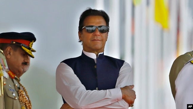 FILE - Pakistan's Prime Minister Imran Khan attends a military parade to mark Pakistan National Day, in Islamabad, Pakistan, March 23, 2022.