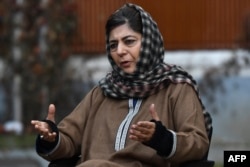 FILE - People's Democratic Party (PDP) leader and former chief minister of Jammu and Kashmir Mehbooba Mufti speaks during a press conference at her house in Srinagar, Dec. 23, 2020.