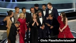 The cast and crew of "CODA" accept the award for best picture at the Oscars, March 27, 2022, at the Dolby Theatre in Los Angeles.