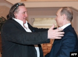 FILE - In this photo taken on Jan. 5, 2013 Russian President Vladimir Putin (R) greets French actor Gerard Depardieu during their meeting in Putin's residence in Sochi.