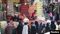 People shop for vegetables hours before a two-month nationwide truce is to take effect, in Sanaa, Yemen, April 2, 2022. 