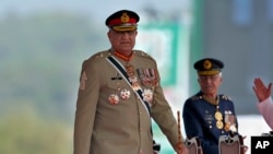 FILE - Pakistan's military chief, General Qamar Javed Bajwa, arrives to attend a military parade in Islamabad, Pakistan, March 23, 2022.