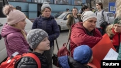 Evacuees from the Mariupol region arrive at reception center, as Russia's invasion of Ukraine continues, in Zaporizhzhia, Ukraine, March 31, 2022.
