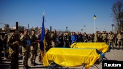 A funeral is held for two Ukraine soldiers who were killed in battle during Russia's attack on Ukraine, at the Lychakiv cemetery in Lviv, Ukraine, March 28, 2022.