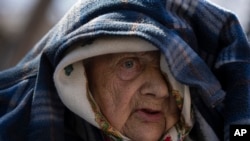 Sofia Boiko, 90 years old, arrives at the Ukrainian Red Cross center in Mykolaiv, southern Ukraine, on March 28, 2022. Boiko who is traveling alone and other people evacuated from regions that have been attacked by the Russian army in Mykolaiv district.