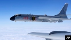 FILE - In this Nov. 23, 2017, photo released by Xinhua News Agency, a Chinese military H-6K bomber is seen conducting training exercises, as the People's Liberation Army Air Force conducted a combat air patrol in the South China Sea.