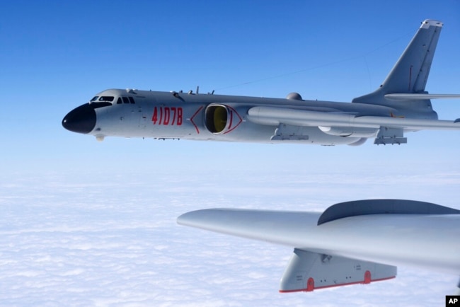 In this Nov. 23, 2017, photo released by Xinhua News Agency, a Chinese military H-6K plane is seen training as the People's Liberation Army Air Force military air watch in the South China Sea. (Wang Guosong/Xinhua via AP)