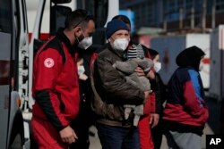 Refugees from Lviv, Ukraine, arrive at a Red Cross headquarters in Rome, March 22, 2022.