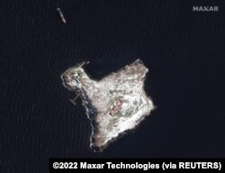 FILE - A satellite image shows an overview of Snake Island and Russian Ropucha ship, March 13, 2022.