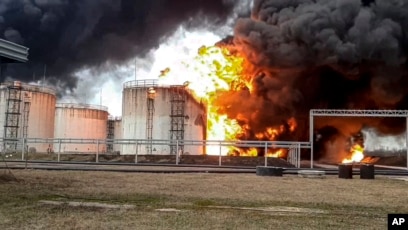 A Russian oil refinery ablaze after a drone strike, showcasing the vulnerability of its critical energy infrastructure. (voanews.com)
