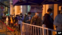 FILE - Residents line up for COVID test in Shanghai, China, March 29, 2022.