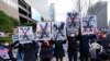 Protesters hold up posters during a rally denouncing North Korea's missile launch near the US Embassy in Seoul, South Korea, March 26, 2022. 
