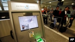 FILE - Arriving passengers wait in the customs clearance area at Los Angeles International Airport, May 28, 2010. Three Muslim Americans have filed a lawsuit alleging that U.S. border officers questioned them about their religious beliefs.