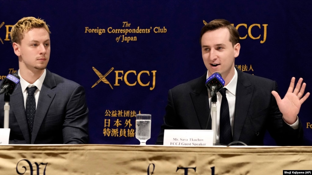 Ukraine's YouTubers, Sava Tkachov, right, speaks as his young brother Yan Tkachov listens to a press conference at the Foreign Correspondents Club of Japan in Tokyo, Thursday, March 31, 2022. (AP Photo/Shuji Kajiyama)