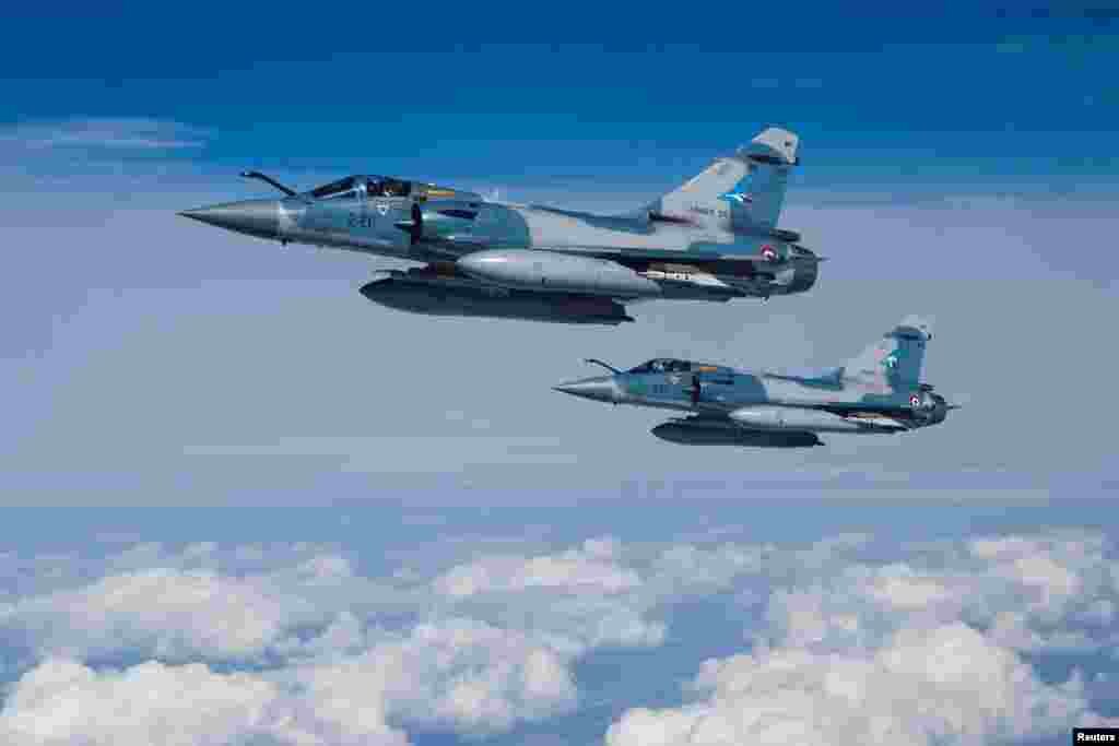 Two Mirage 2000-5F fighter jets of the French Air Force fly next to an Airbus A330 MRTT &quot;Phenix&quot; in the airspace of Poland as part of NATO&#39;s Air Policing (eAP) effort to defend airspace over Baltic allies. (REUTERS/Benoit Tessier )