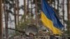 Ukrainian troops in an armored vehicle advance outside Kyiv, Ukraine, March 31, 2022.