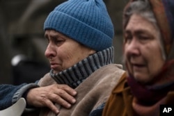 Evacuated residents from Irpin gather in an assistance center in the outskirts of Kyiv, Ukraine, March 30, 2022.