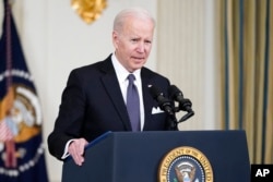 President Joe Biden speaks about Russian President Vladimir Putin and Russia's invasion of Ukraine, in the State Dining Room of the White House in Washington, March 28, 2022.