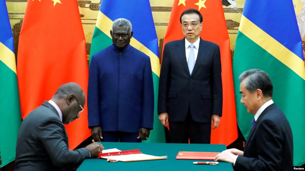 FILE - From left, Solomon Islands Prime Minister Manasseh Sogavare, Foreign Minister Jeremiah Manele, Chinese Premier Li Keqiang and Foreign Minister Wang Yi attend a signing ceremony at the Great Hall of the People in Beijing, China October 9, 2019. (REUTERS)