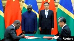 FILE - From left, Solomon Islands Prime Minister Manasseh Sogavare, Foreign Minister Jeremiah Manele, Chinese Premier Li Keqiang and Foreign Minister Wang Yi attend a signing ceremony at the Great Hall of the People in Beijing, China October 9, 2019. (REUTERS)