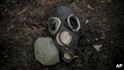 A damaged gas mask lies on the pavement at a Russian position that had been overrun by Ukrainian forces, outside Kyiv, Ukraine, March 31, 2022.
