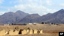 FILE- Mes Aynak valley is seen some 40 kilometers southwest of Kabul, Afghanistan, March 2, 2022. The valley holds the world's second-largest unexploited copper deposit. Buildings on top are offices of a Chinese mining company MCC.