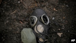 A damaged gas mask lies on the pavement at a Russian position which was overrun by Ukrainian forces, outside Kyiv, Ukraine, March 31, 2022. 