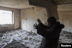 Local resident Marina Sidorenko, 83, shows her apartment in a multi-storey building burnt-out in the course of Ukraine-Russia conflict in the southern port city of Mariupol, Ukraine April 1, 2022.