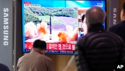 FILE - People watch a TV showing a file image of North Korea's missile launch during a news program at the Seoul Railway Station in Seoul, South Korea, March 24, 2022.