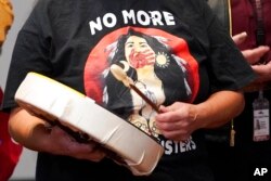 Monie Ordonia, of the Tulalip Indian Tribe, plays a drum after Washington Gov. Jay Inslee signed a bill that creates a first-in-the-nation statewide alert system for missing Indigenous people, in Quil Ceda Village, near Marysville, Wash., March 31, 2022.