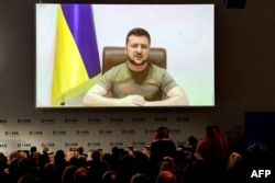 Ukraine's President Volodymyr Zelensky remotely addresses by video-link the Doha Forum in Qatar's capital on March 26, 2022.