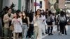 FILE - People wearing face masks to protect against the spread of the coronavirus go shopping in Taipei, Taiwan, Nov. 21, 2021.