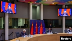 FILE - European Union foreign policy chief Josep Borrell, left, and European Council President Charles Michel participate in a virtual EU China summit at the European Council building in Brussels, Belgium, April 1, 2022.