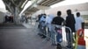 FILE - Migrants from Africa, Central America and Haiti wait to see if their numbers will be called to cross the border and apply for asylum in the United States, at the El Chaparral border crossing in Tijuana, Mexico, Sept. 13, 2019.