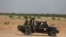 FILE - Niger's army soldiers ride on a pickup truck near Agadez, Niger, Oct. 29, 2019.
